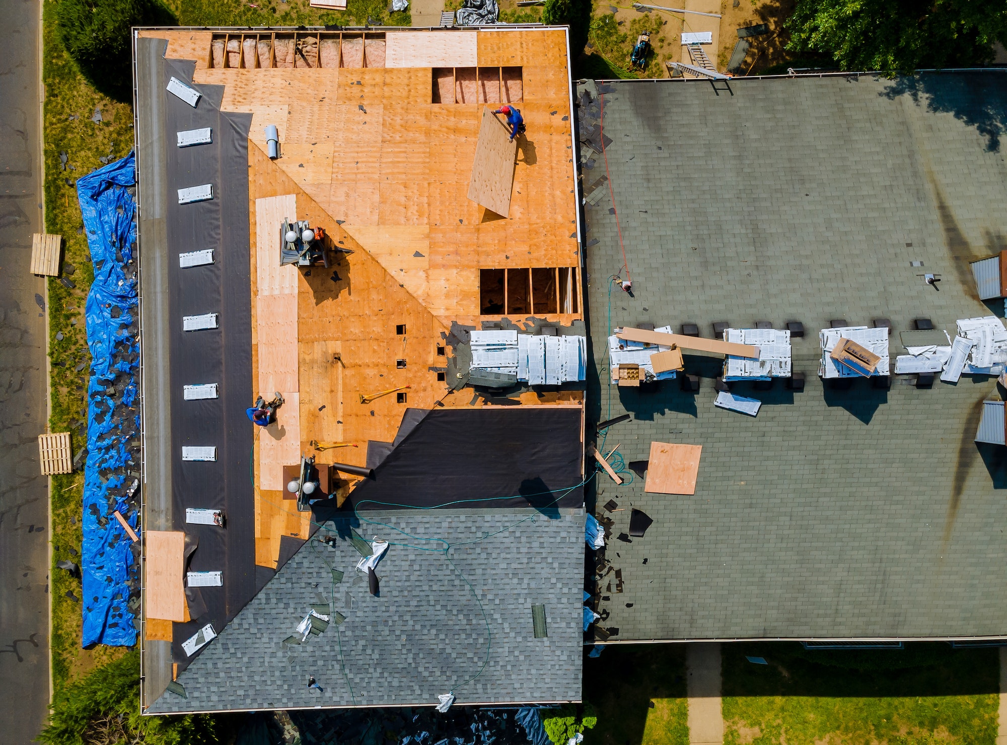 Construction worker on renovation roof the house installed new shingles